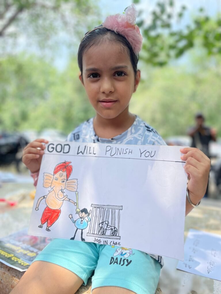 A girl holds a hand-drawn poster.